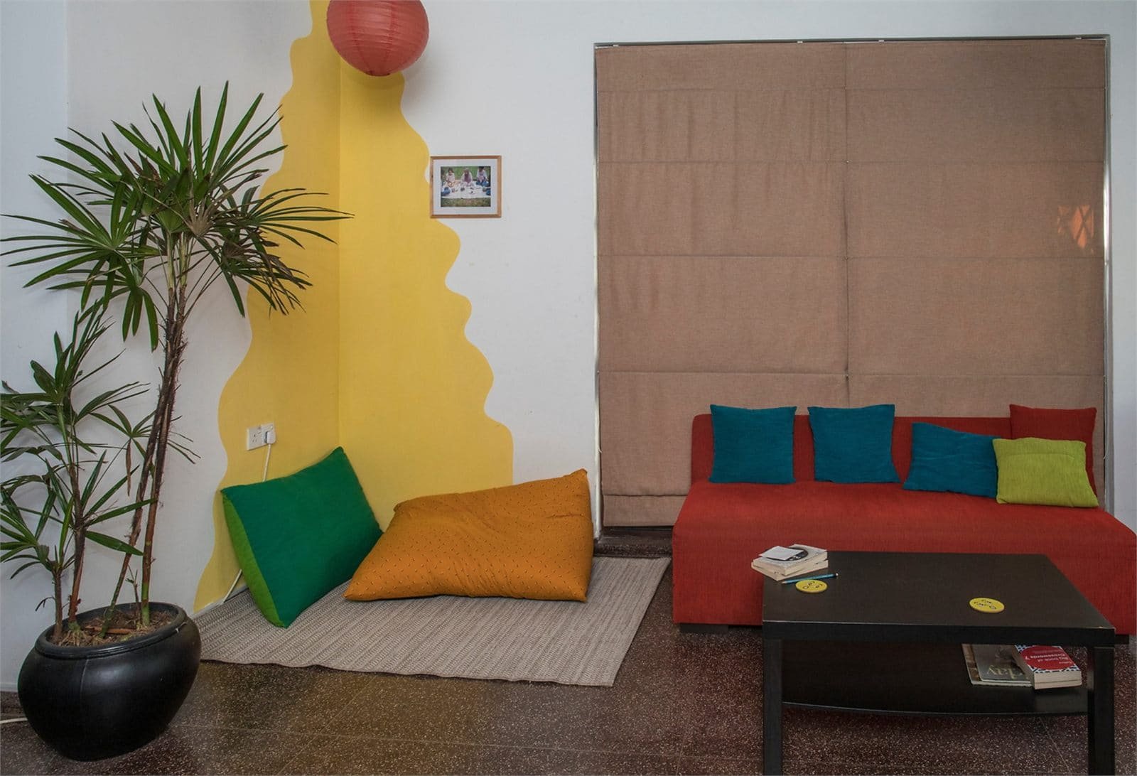 The common living area in the CAFS home, with red sofas, bookshelves and plants